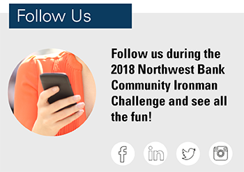 Image of a hand with a smartphone stating follow us during the 2018 Northwest Bank Ironman Challenge