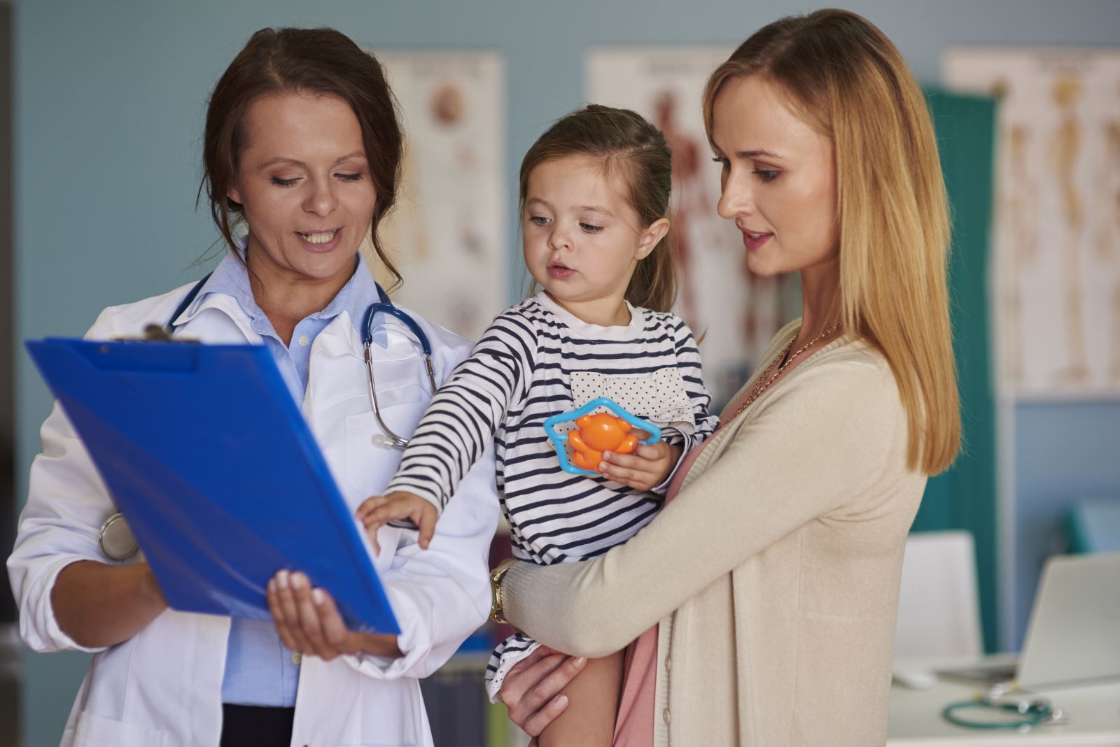 Image of a mother and child with a doctor looking at a chart image