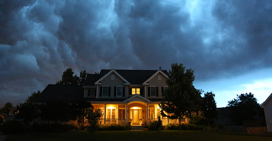 image of  house with storm clouds above
