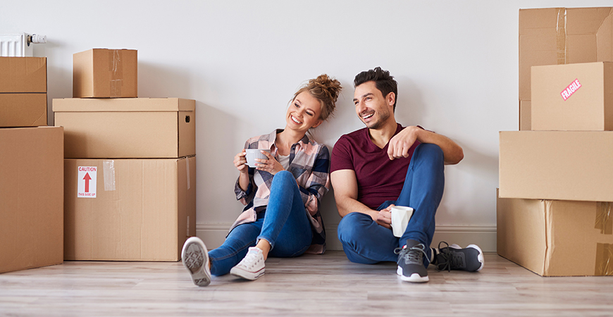 image of couple looking at boxes from move