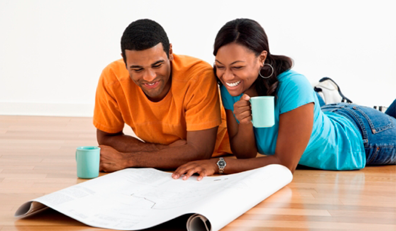 Image of a young couple looking at floor plans