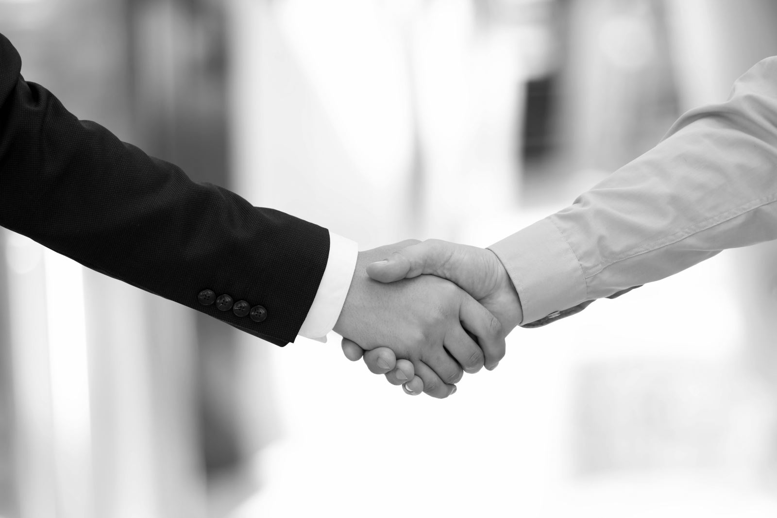 Black and white image of two men shaking hands